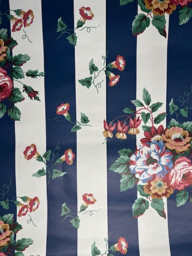 Vintage wallpaper with navy and cream stripes, trailing morning glory vines, and pink floral bouquets